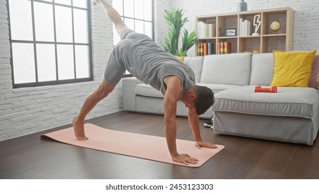 A fit man practices yoga indoors, balancing in a challenging posture on a mat in a bright, modern living room. - Powered by Shutterstock