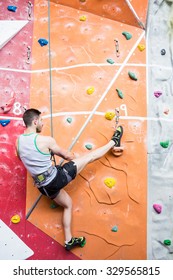 Fit Man Rock Climbing Indoors At The Gym