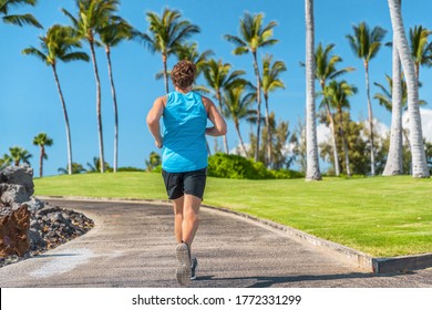 Fit Man Runner Running Outdoor On City Boardwalk With Palm Trees Background. Young Athlete Run Training Fitness Jogging In Summer Sun. Healthy Active Florida Or Hawaii Lifestyle.