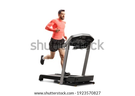 Fit man running on a treadmill isolated on white background