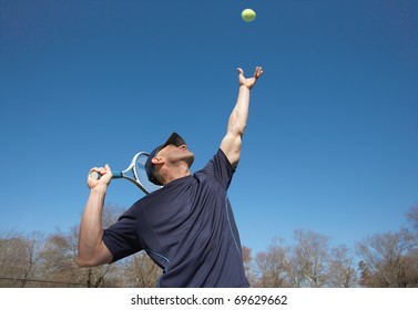 Fit Man Serving Tennis Ball Serve Outside