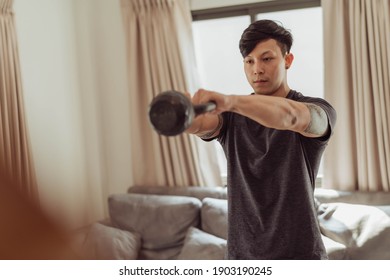 Fit man in sportwear doing exercise with kettlebell at home. Young man workout  at home. - Powered by Shutterstock