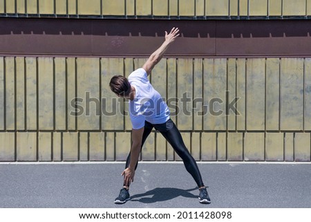 Similar – Athletic man warming up before running.