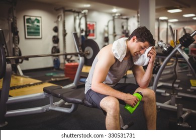 Fit man taking a break from working out at the gym - Powered by Shutterstock