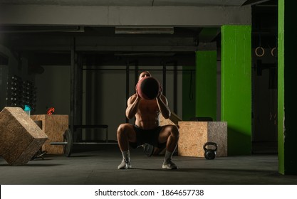 Fit Man Throwing Medicine Ball Doing Ball Slam Against Gym Floor Or Shoulder Press Exercise.