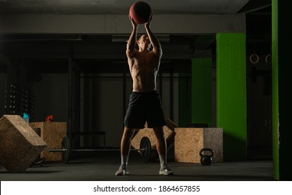 Fit Man Throwing Medicine Ball Doing Ball Slam Against Gym Floor Or Shoulder Press Exercise.