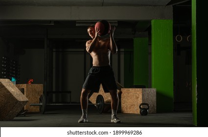 Fit Man Throwing Medicine Ball Doing Ball Slam Against Gym Floor Or Shoulder Press Exercise.