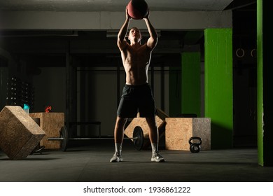 Fit Man Throwing Medicine Ball Doing Ball Slam Against Gym Floor Or Shoulder Press Exercise.