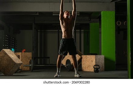 Fit Man Throwing Medicine Ball Doing Ball Slam Against Gym Floor Or Shoulder Press Exercise.