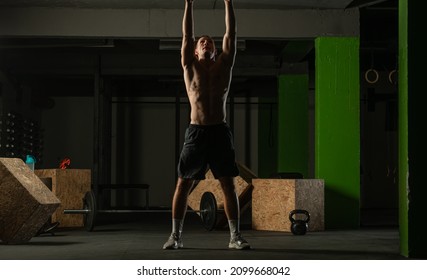 Fit Man Throwing Medicine Ball Doing Ball Slam Against Gym Floor Or Shoulder Press Exercise.