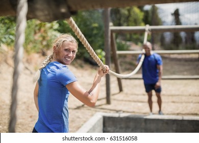 Fit man and woman practicing during obstacle course in boot camp - Powered by Shutterstock