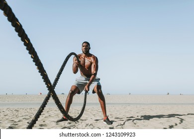 Fit Man Working Out With Battle Ropes