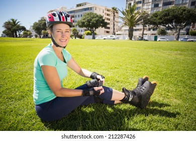 Fit Mature Woman In Roller Blades On The Grass On A Sunny Day