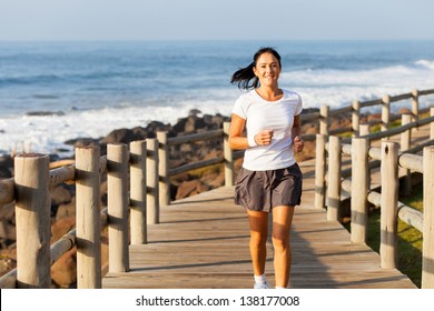 Fit Mid Age Woman Jogging At The Beach In The Morning