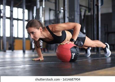 Fit and muscular woman exercising with medicine ball at gym. - Powered by Shutterstock