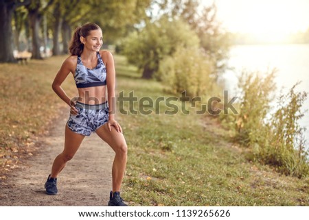 Fit muscular woman working out in a park