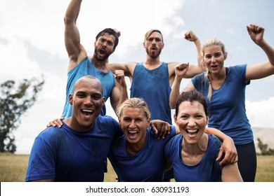 Fit people cheering together in boot camp - Powered by Shutterstock