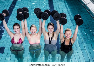 Fit People Doing An Aqua Aerobics Class In Swimming Pool