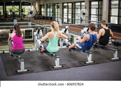 Fit people on drawing machine at gym