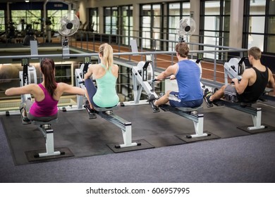 Fit people on drawing machine at gym