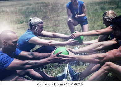 Fit people performing core exercise in bootcamp - Powered by Shutterstock