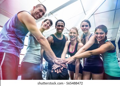 Fit People Putting Their Hands Together In Gym