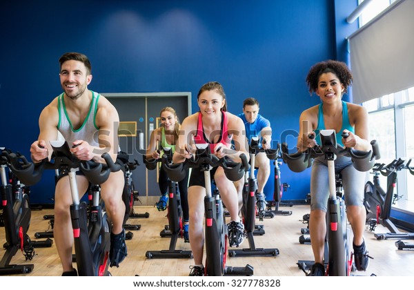 Fit people in a spin class\
the gym