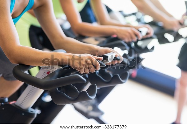 Fit people in a spin\
class at the gym