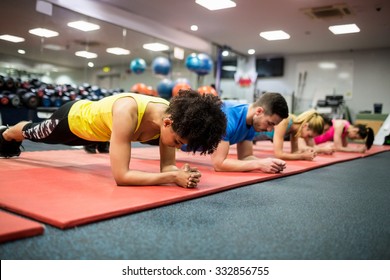 Fit people working out in fitness class at the gym