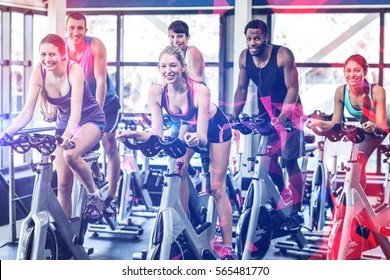 Fit People Working Out At Spinning Class In The Gym