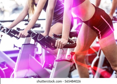 Fit People Working Out At Spinning Class In Gym