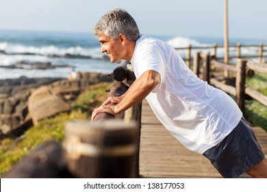 fit senior man exercising at the beach in the morning - Powered by Shutterstock