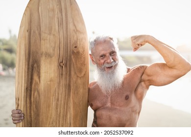 Fit Senior Man Having Fun Practicing Surf On Tropical Beach - Elderly Healthy People Lifestyle And Extreme Sport Concept