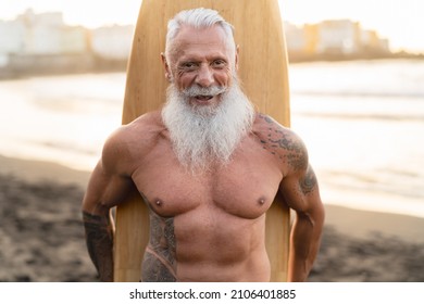 Fit Senior Man Having Fun Surfing On Tropical Beach - Elderly Healthy People Lifestyle And Extreme Sport Concept