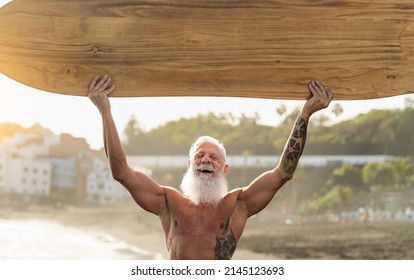 Fit Senior Man Having Fun Surfing On Tropical Beach - Elderly Healthy People Lifestyle And Extreme Sport Concept