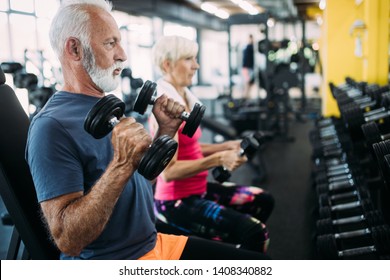 Fit Senior Sporty Couple Working Out Together At Gym