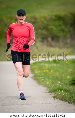 Similar – Blick auf den älteren Mann, der durch den Park joggt.