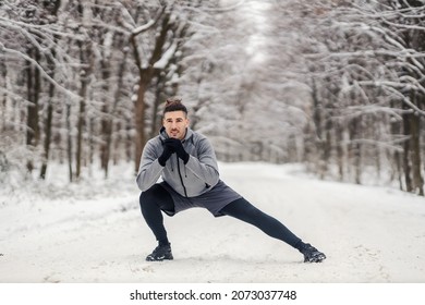 Fit Sportsman Doing Stretching And Warmup Exercises In Forest At Snowy Winter Day. Healthy Life, Warmup, Cold Weather