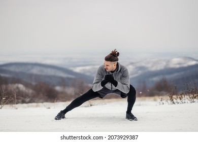 A Fit Sportsman Doing Warmup Exercises On The Snow At Winter. Healthy Lifestyle, Winter Fitness