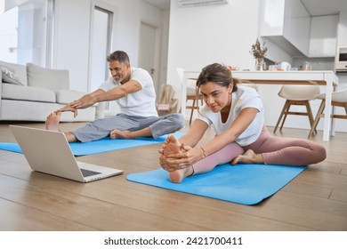 Fit sporty middle aged family couple stretching at home looking at laptop. Healthy mature older man and woman doing sport fitness exercises together watching workout body care tutorial in living room. - Powered by Shutterstock