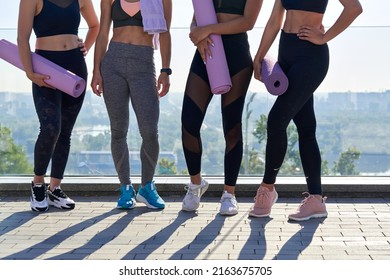 Fit Sporty Multiracial Women Friends Wear Sportswear Hold Yoga Mats Standing Outdoor Together. Group Fitness Classes Outside, Pilates Sport Community, Workout Training Outside Concept. Close Up Legs.