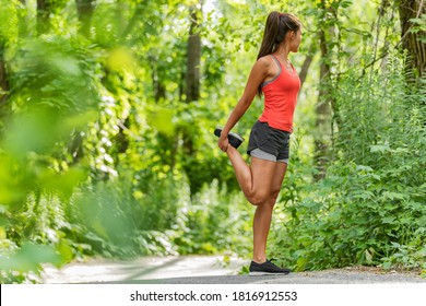 Fit Stretch Woman Stretching Quad Leg Muscle Standing Getting Ready To Run Jogging Outside In Summer Nature Forest Park Green Trees Background. Fitness Runner Athlete Running Girl.