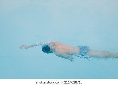 Fit Swimmer Male Training Swim In Open Winter Swimming Pool With Fog. Geothermal Outdoor Spa Health Concept,