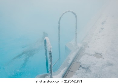 Fit Swimmer Male Training Swim In Open Winter Swimming Pool With Fog. Geothermal Outdoor Spa Health Concept.