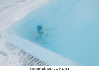 Fit Swimmer Male Training Swim In Open Winter Swimming Pool With Fog. Geothermal Outdoor Spa Health Concept.