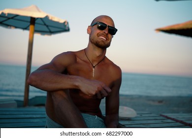 Fit Tanned Man Smiling At The Beach. Holiday Concept.