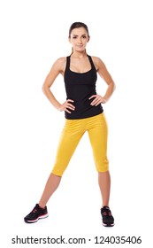 Fit Woman Athlete In Gym Clothes Posing Standing Facing The Camera With Her Hands On Her Hips On White