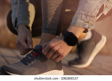 Fit Woman Checking Smart Watch Wearable Technology, Sport Smartwatch On Fitness Run Walk Outside. Top View From Above With Running Shoes In Street.