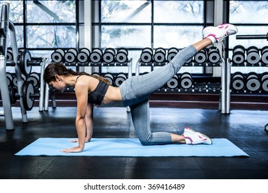 Fit woman doing fitness exercises at the gym