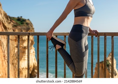 Fit Woman Doing A Quad Stretch By The Sea, Close Up